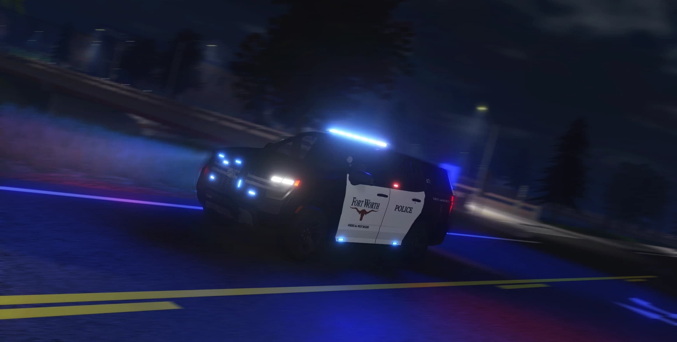 Fort Worth Police SUV on the road at night with its emergency lights on